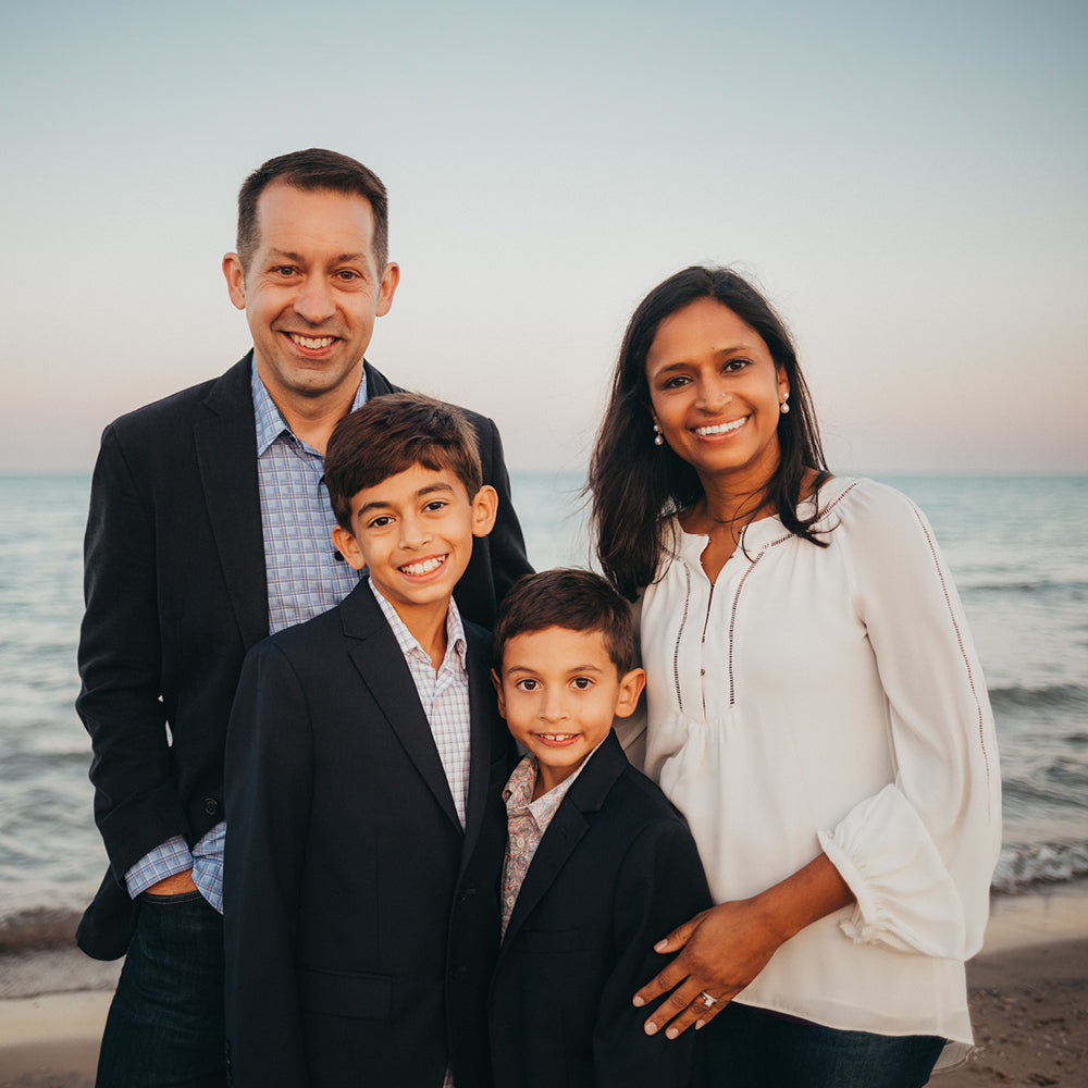 Chad Kase with his wife and two sons at the beach.